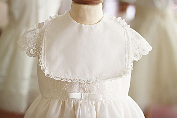 Bavoir de cérémonie bébé en coton et bordure dentelle. A porter avec une robe de baptême. Bavoir de cérémonie bébé en coton et bordure dentelle. A porter avec une robe de baptême. Vue rapprochée.