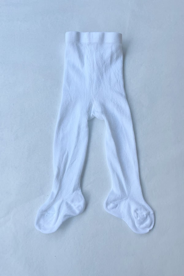 Collant blanc épais en coton chaud pour bébé fille. Idéal à porter avec une robe de cérémonie bébé blanche. Boutique Fil de Légende à Paris, Neuilly-sur-Seine.