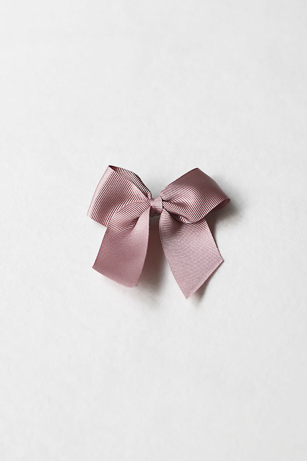 Pince cheveux noeud en gros grain de couleur vieux rose. Parfait pour sublimer une coiffure de petite fille à l'occasion d'une cérémonie. Boutique Fil de Légende à Paris, Neuilly-sur-Seine.