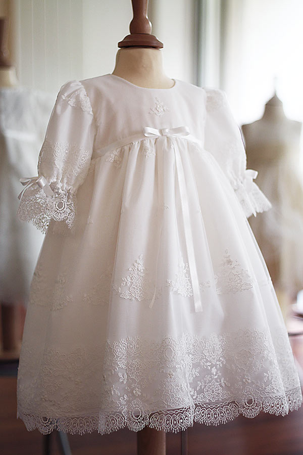 Robe de baptême pour bébé et petite fille en tulle brodé italien, doublée de coton, modèle printemps à manches longues. Création Fil de Légende. Vue de côté.