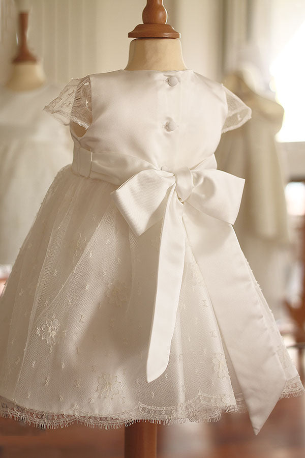 Robe de baptême ou de cérémonie pour bébé et petite fille en dentelle de Calais, doublée de satin, modèle été à manches courtes. Création Fil de Légende. Photo de la robe vue de dos.